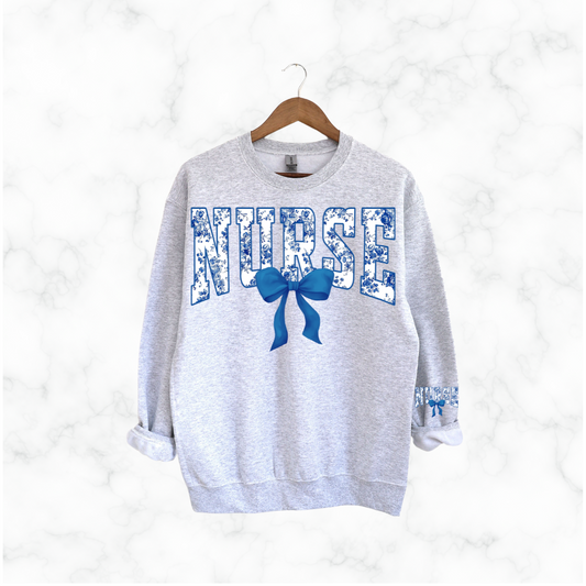 NURSE FLORAL BLUE BOW SWEATSHIRT